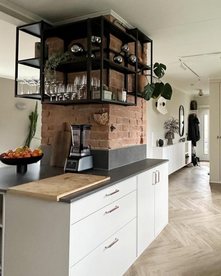 black metal shelving unit in kitchen from @thefabulousmum showcasing ikea enhet ideas with brick wall backdrop and glassware display