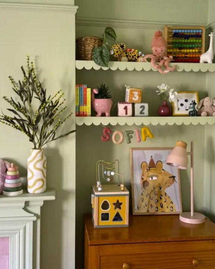 Cream scalloped shelf trim from CraftyMDF for ikea mosslanda hacks & ideas in a colorful nursery display