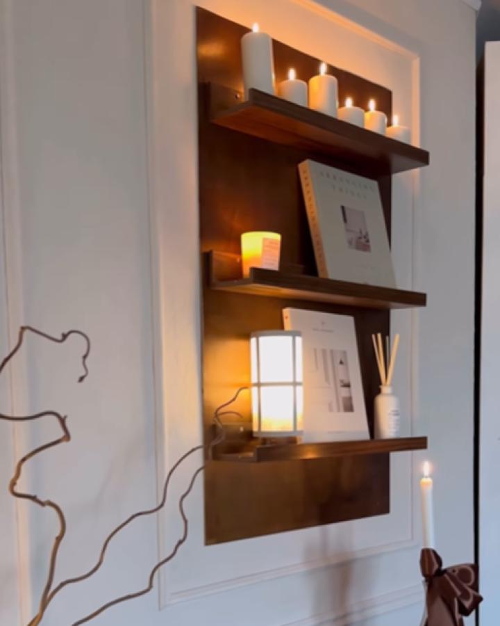Dark wood floating shelves from @interiorxlifestyle with warm LED backlighting and candle display.
