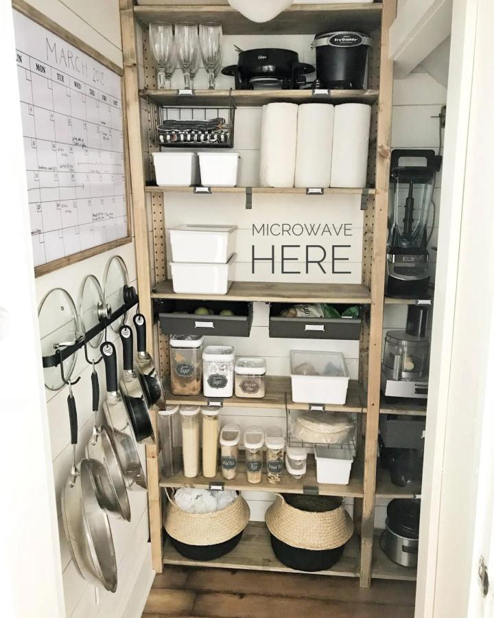 Clean white and wood pantry shelving from Proverbs 31 Girl. Door rack and labeled bins for ikea pantry ideas.