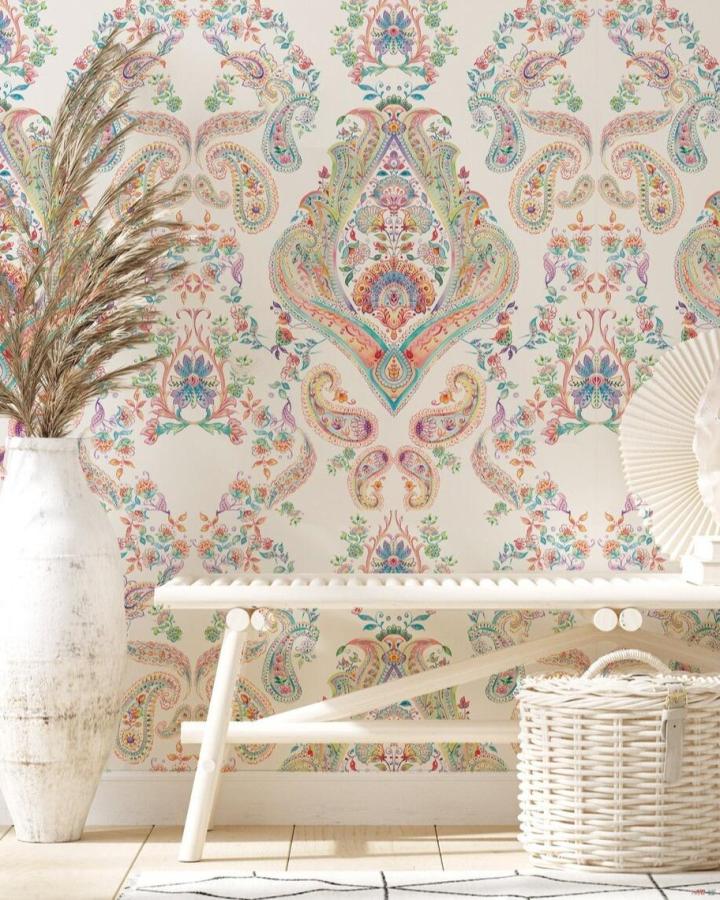 Colorful paisley peel & stick wallpaper in a cozy corner with natural wood bench and wicker basket