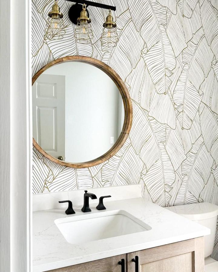 Cream background peel & stick wallpaper ideas with thin olive leaf pattern in bathroom from @thinknoir_wallpaper.