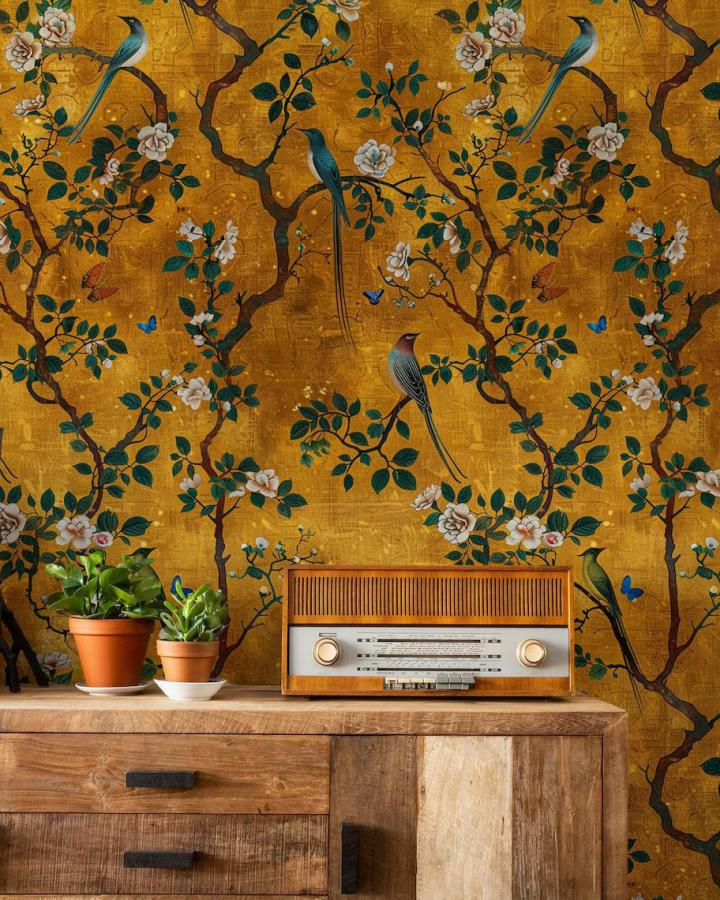 golden botanical peel & stick wallpaper ideas with birds and branches in a cozy room setting