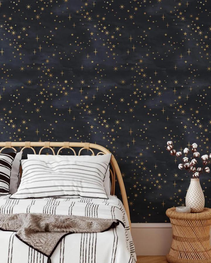 Dark navy starry sky peel & stick wallpaper ideas in bedroom from CheerfulWalls with golden stars and cozy natural decor.