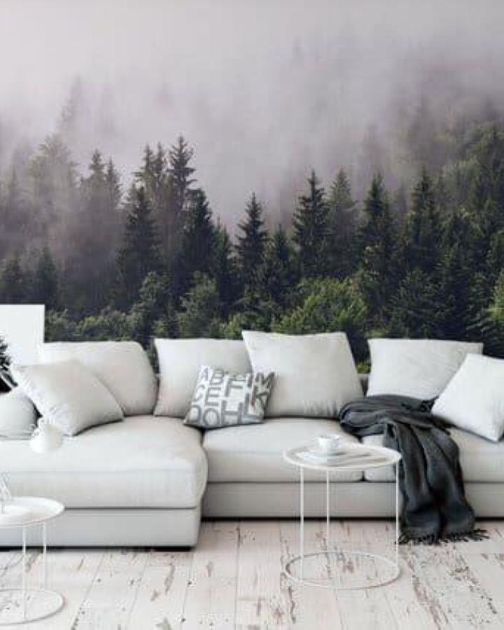 Green misty pine forest peel & stick wallpaper ideas from BonnieBoldWallpaper on Etsy. Large-scale nature scene behind white sofa.