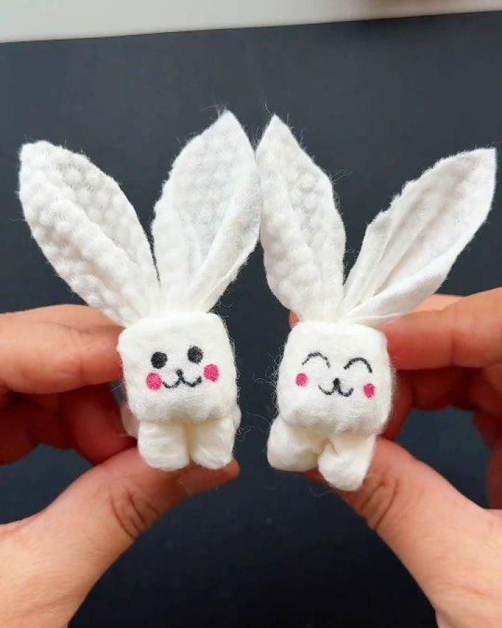 White cotton pad Easter bunny crafts for adults from @paper.crafts.in showing cute hand-drawn faces and soft textured ears.