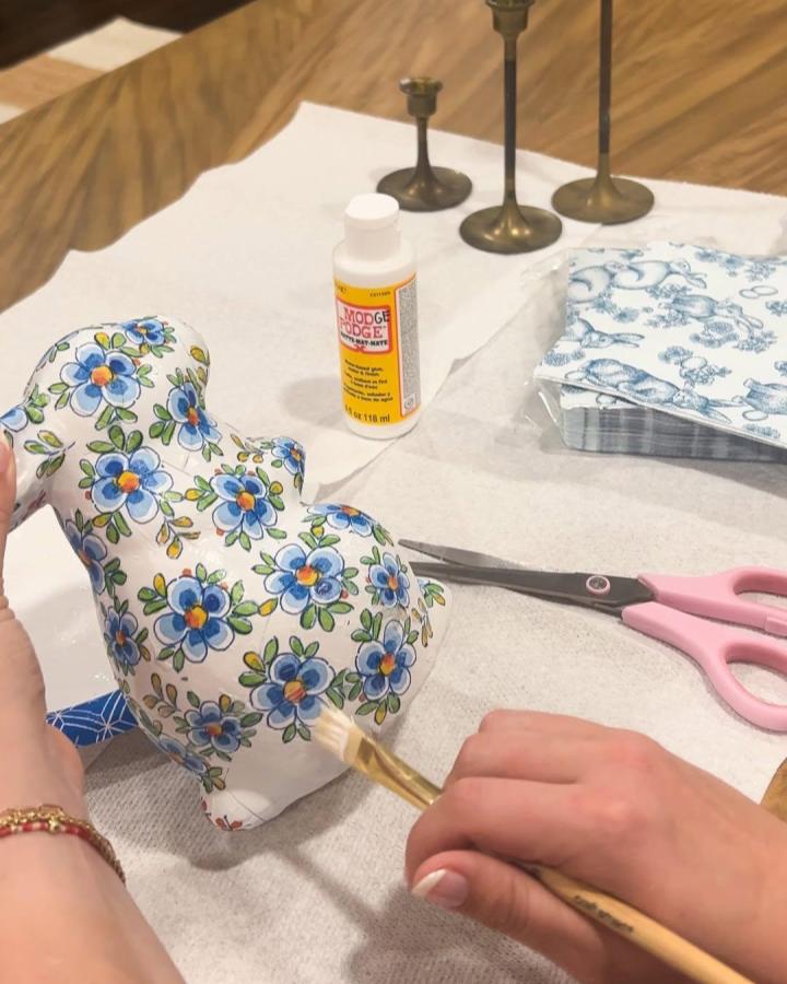 Blue floral patterned fabric bunny craft from @kenziemariehome with Mod Podge brush and scissors in use for easter bunny crafts for adults.