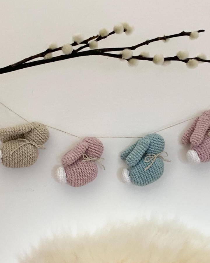 knitted pastel bunny garland from @ellenkantarellen hanging with pussy willow branch soft easter bunny crafts for adults decoration