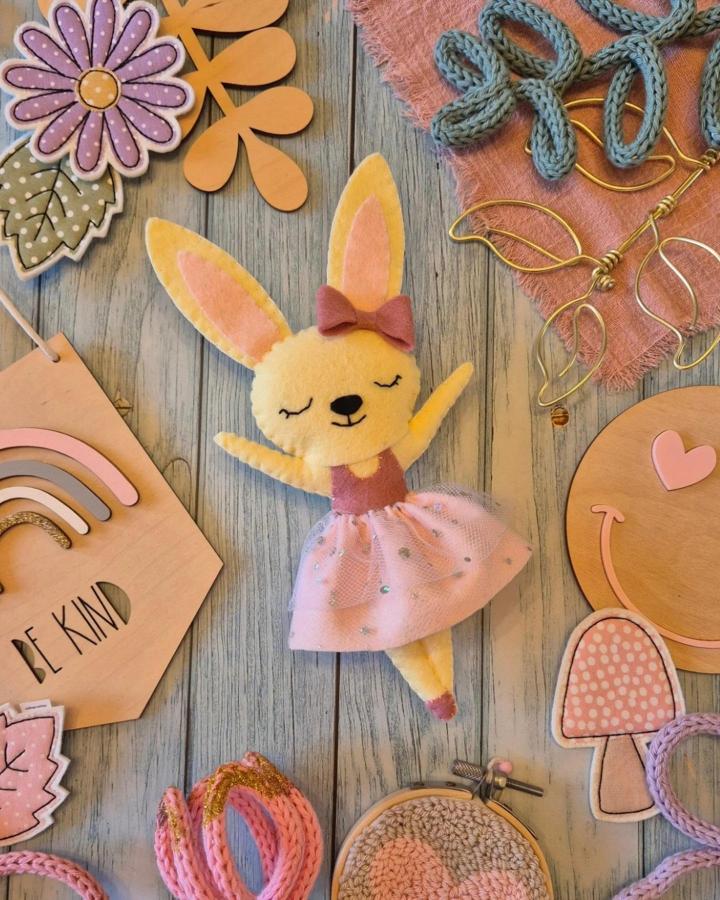 Yellow and pink felt bunny doll with tulle skirt and embroidered face for easter bunny crafts for adults from @vkaycreations.