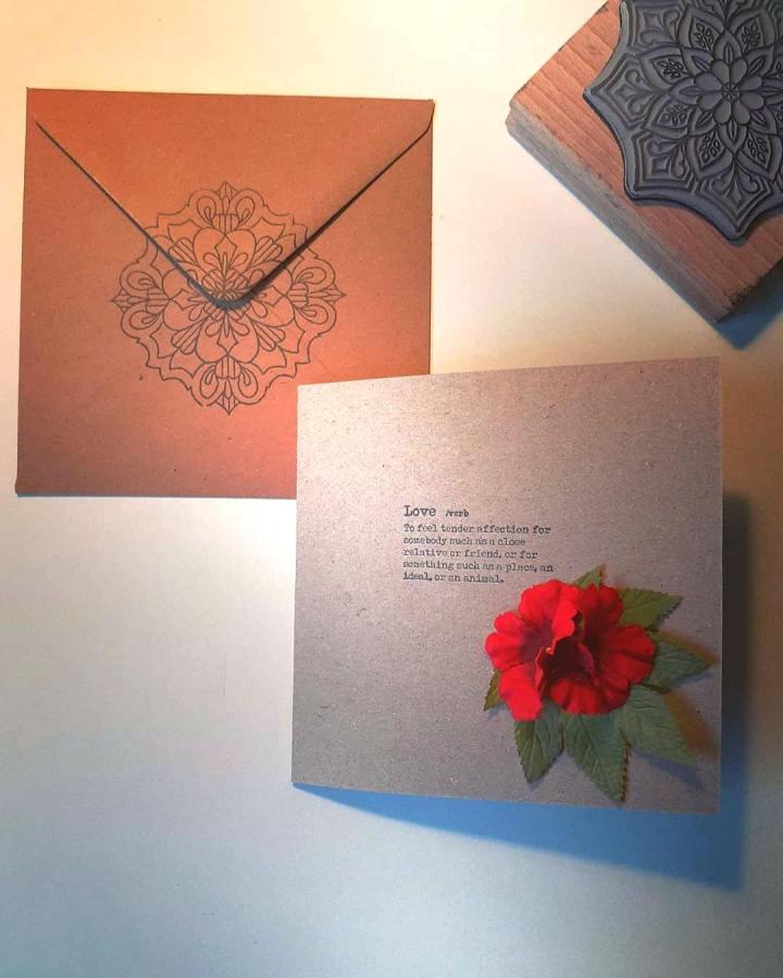 brown kraft paper card with red flower and stamped envelope from @birdyfloraldesign handmade valentines card ideas simple elegant design