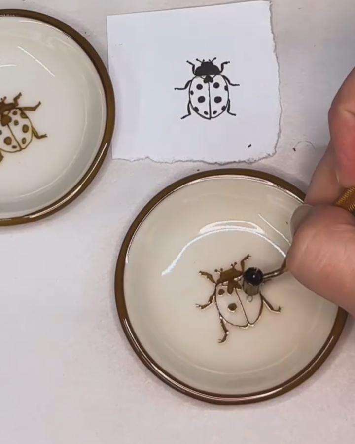Brown and cream ceramic bowls with hand-painted ladybug designs from @apricity.ceramics featuring ladybug crafts for adults.