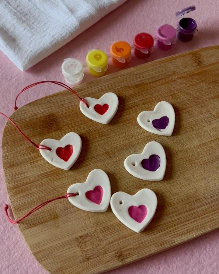 white clay heart tags with red, pink, and purple painted hearts from @numberthreen3 for valentines crafts for kids with red string