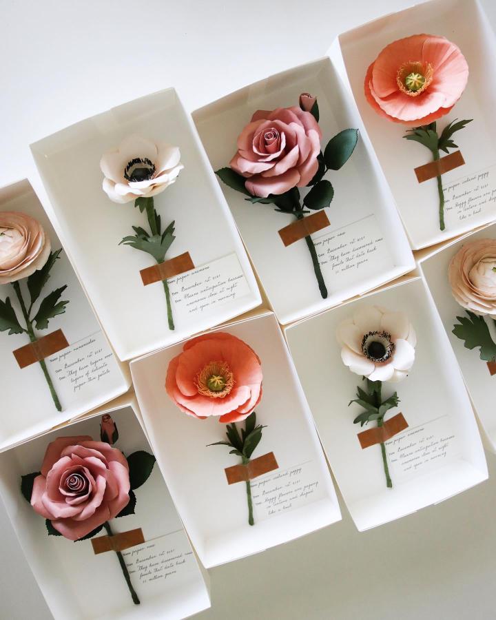 pink and white paper flowers valentines paper craft ideas from @handmadebysarakim displayed in white trays with handwritten notes