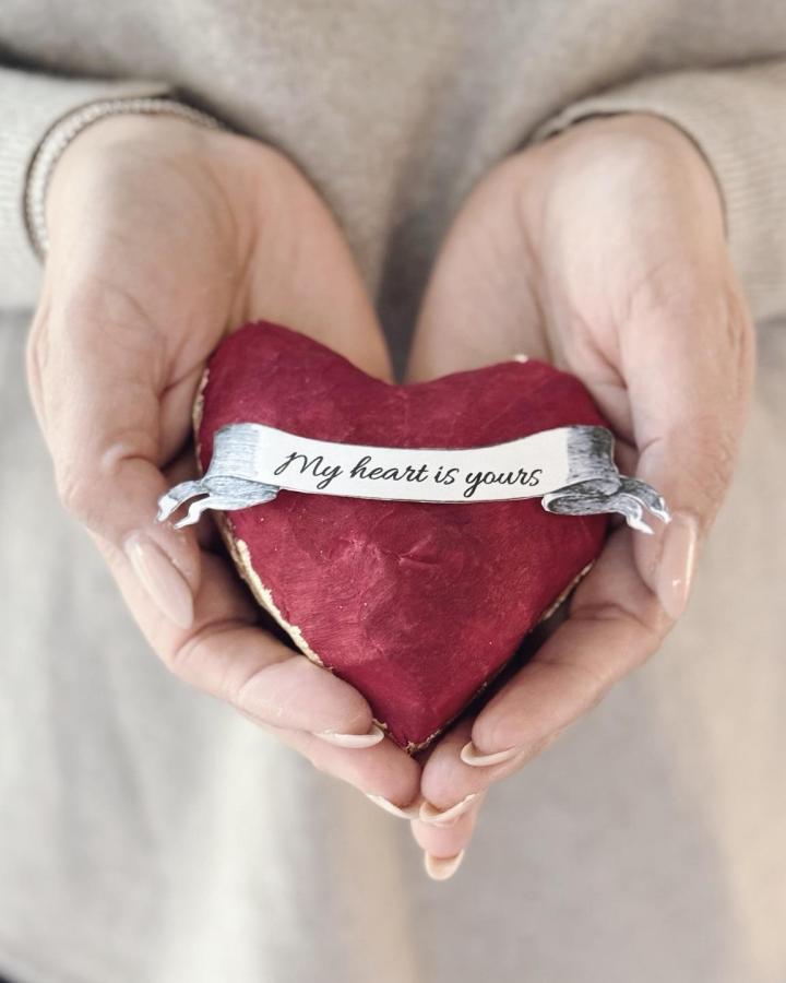 red handcrafted heart with a vintage banner detail from @prettypetals_by_lucy valentines paper craft ideas close up in hands
