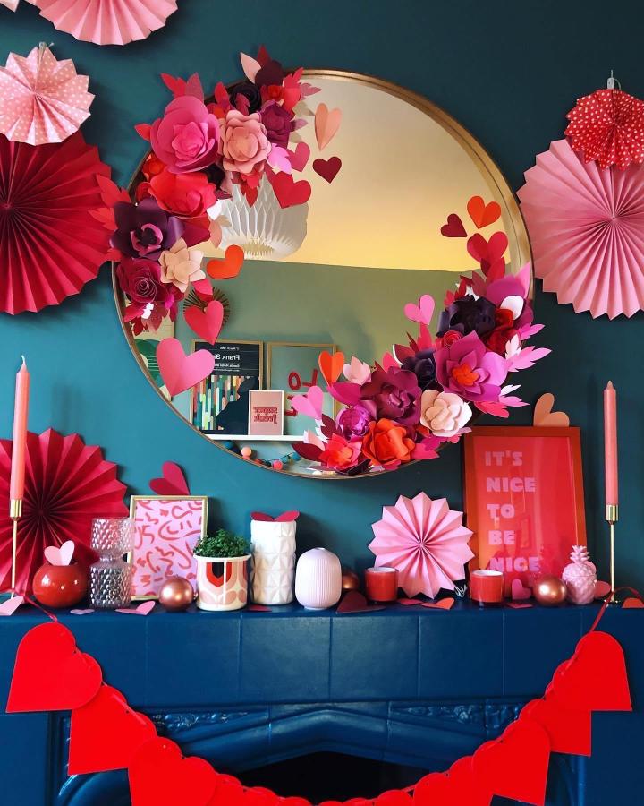 Red and pink paper hearts and flowers with a heart garland on a teal fireplace from @spatownhome valentines paper craft ideas.