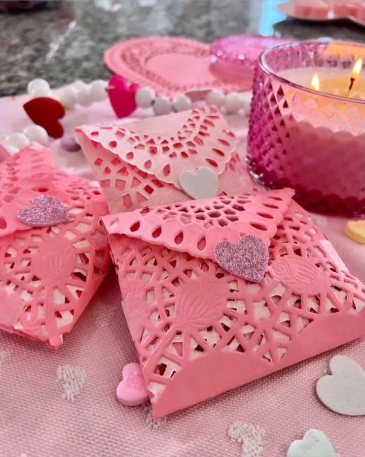 Pink lace paper doily envelopes with glitter heart stickers from @itseverydayryan on valentines paper craft ideas background