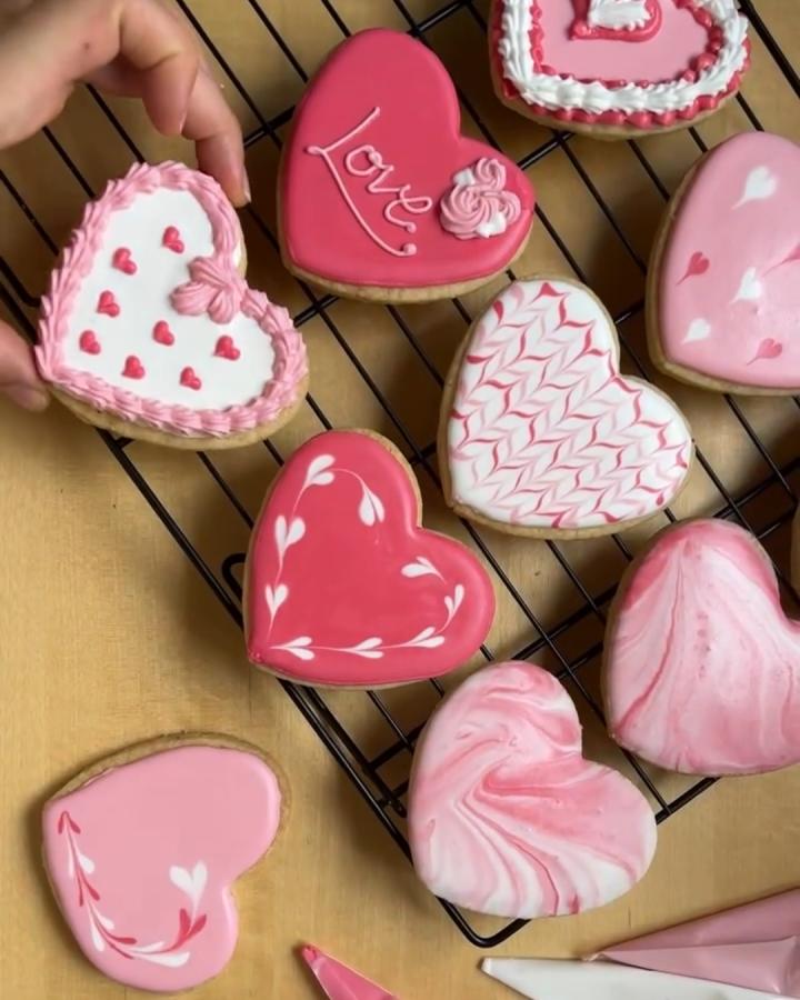 pink and red hand-iced heart cookies with floral and marbled designs from @georgiascakes perfect valentines treat ideas