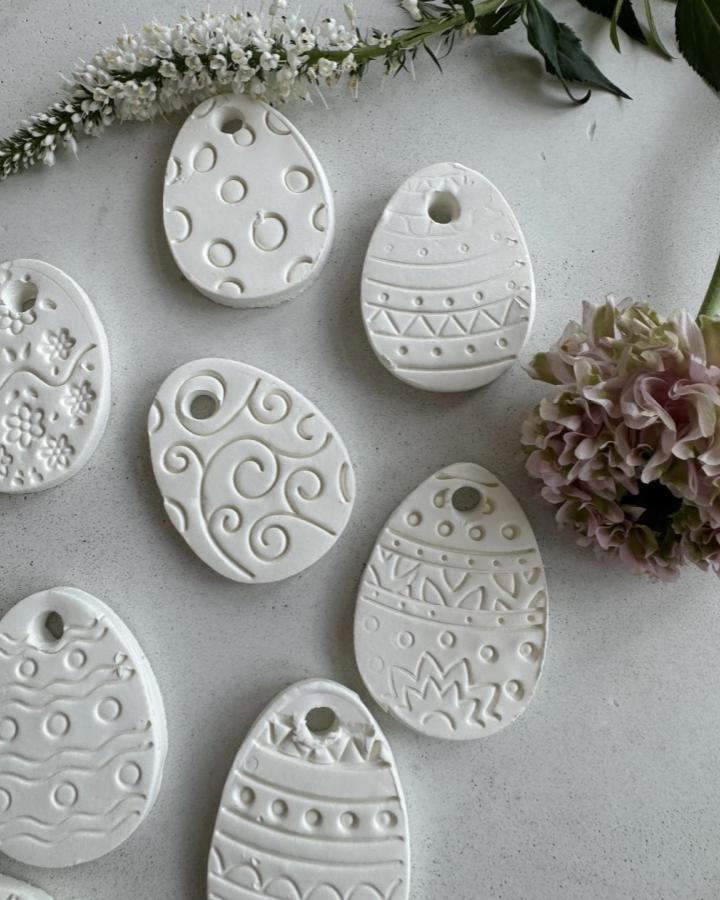white minimalist etched clay Easter egg charms from @ceramicsbyjuliavictoria delicate and simple easter clay craft ideas