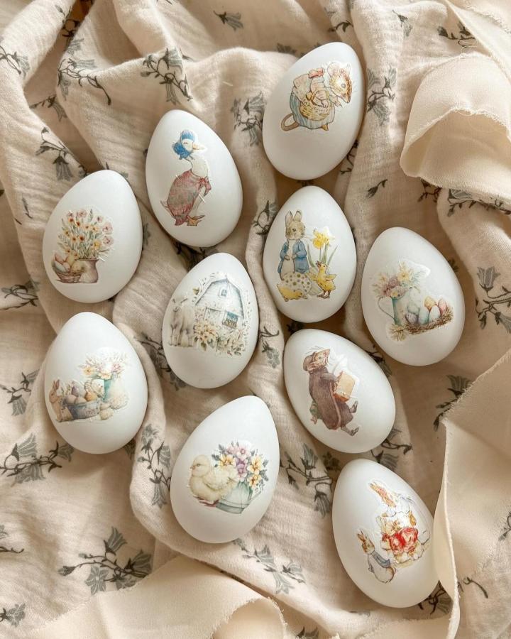 White vintage decoupage eggs arranged on floral fabric from @efi_little_things for easter craft night ideas.