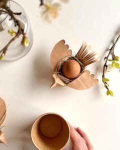 kraft paper bird nest egg holder from @cassolive with natural straw and rustic easter craft night ideas touches