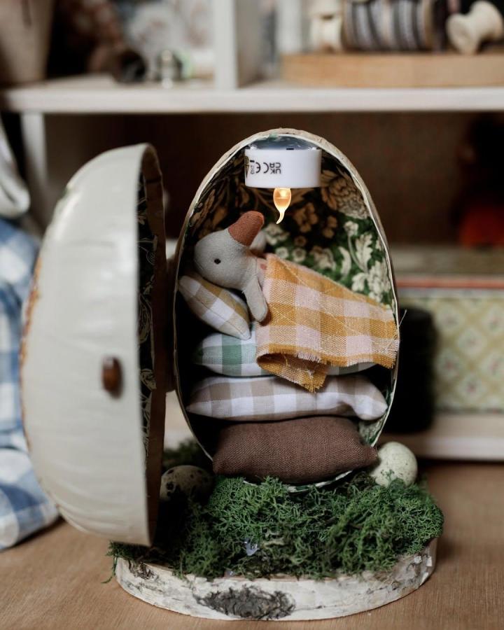 Creamy white egg decoupage with gingham pillows and moss base craft by @story.of.lam for easter craft night ideas.