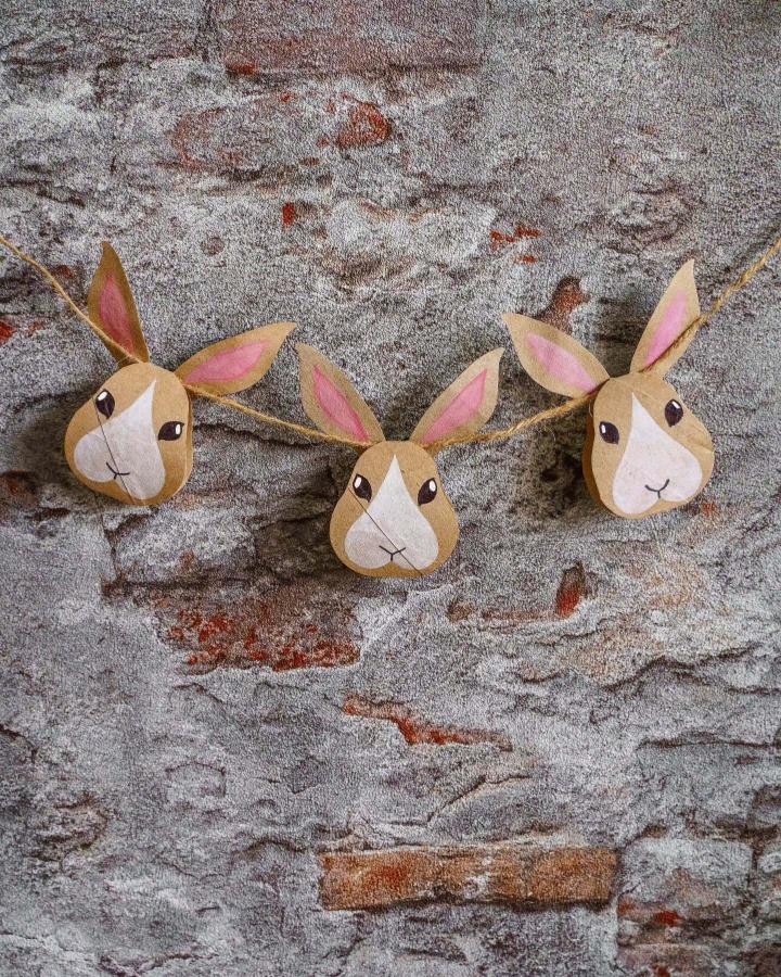 brown paper bunny garland with pink ears and twine string from @mama.jots perfect for easter craft night ideas