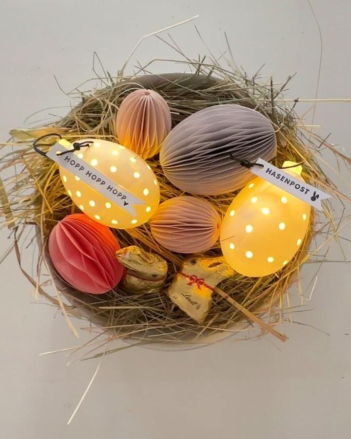 Yellow glowing honeycomb paper eggs in a nest from @liddierowl. Easter craft night ideas with soft pastel decorations.