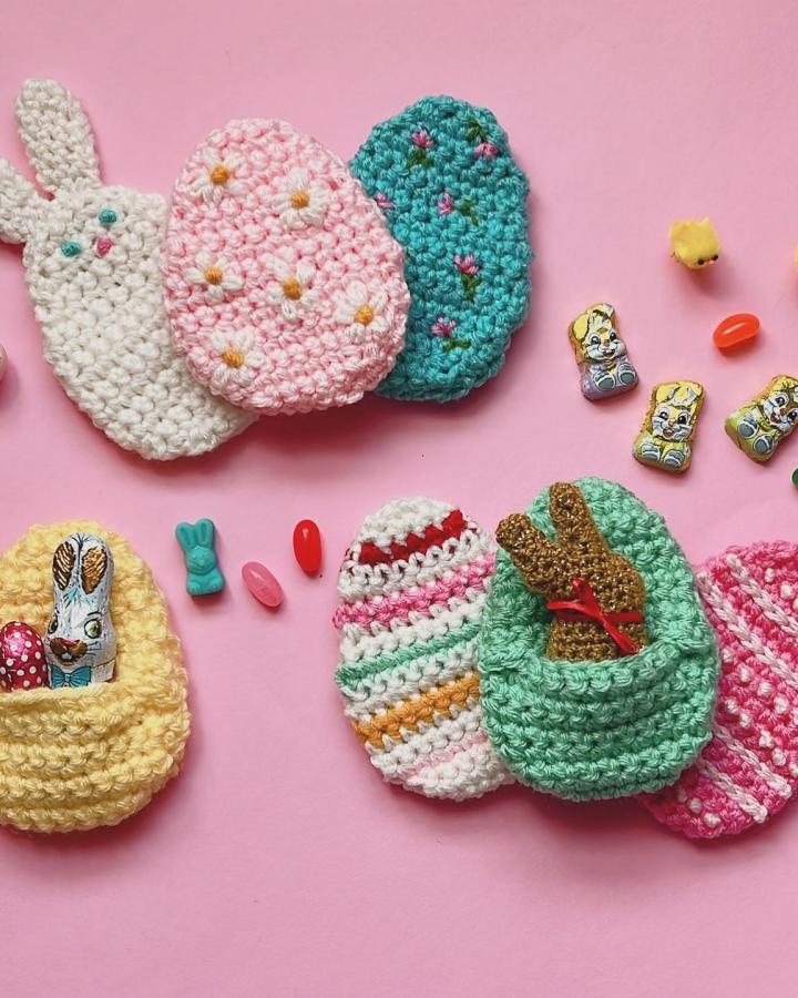 Crochet pastel egg-shaped pouches with bunny and floral details from @pensebonheur Easter crochet ideas for small treat holders.