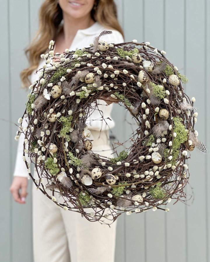 Rustic grapevine wreath with pussy willows, quail eggs, moss, and feathers from @the_suffolk_nest easter wreath ideas natural decor.
