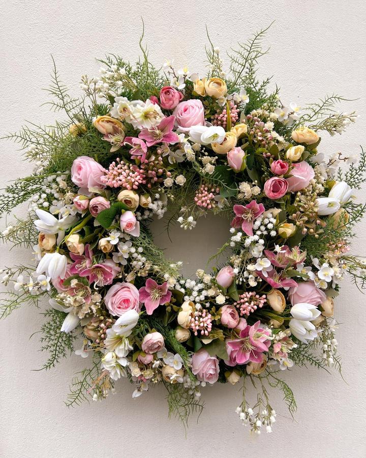Soft pastel floral wreath from @artificial_hannah with mixed greenery perfect for easter wreath ideas and spring decor.