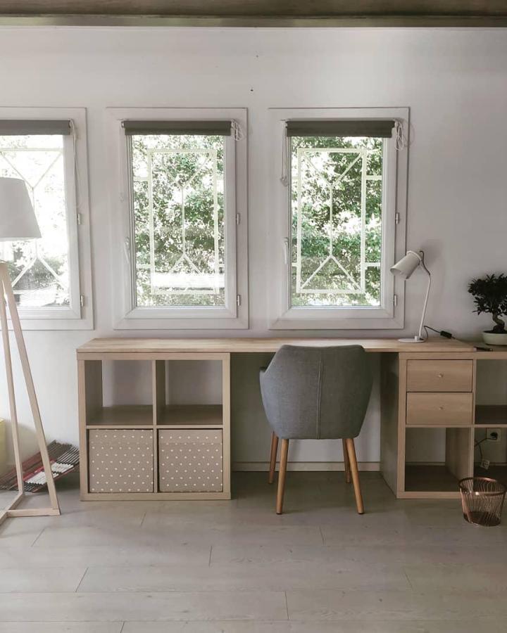 Beige wood minimalist desk with polka dot bins and grey chair from @thienlanw featuring ikea kallax desk hacks & ideas in natural light