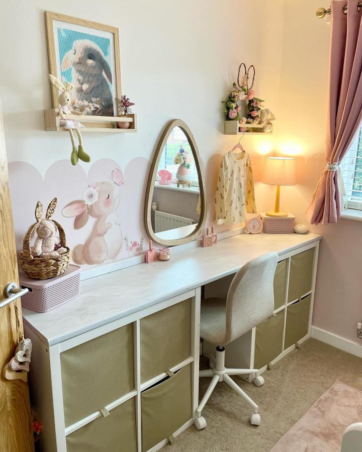 White Kallax unit with beige fabric drawers and pastel accents in a cozy, personalized workspace from @sjw.home. Soft lighting and bunny decor.