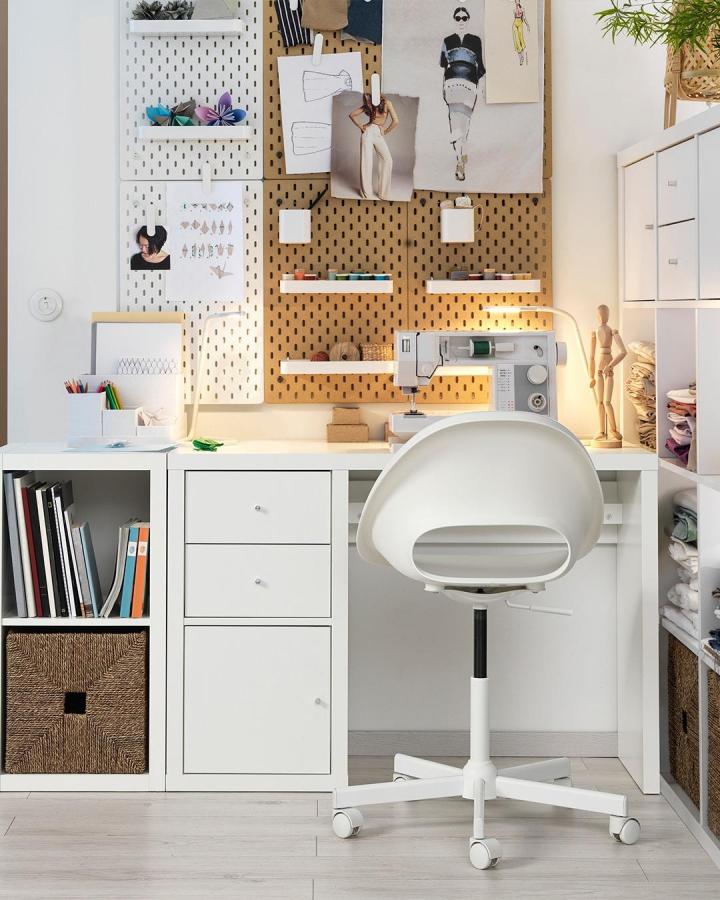 white modern crafting workspace with ikea kallax desk hacks & ideas and pegboard wall storage from @ikea with sewing machine and organized supplies