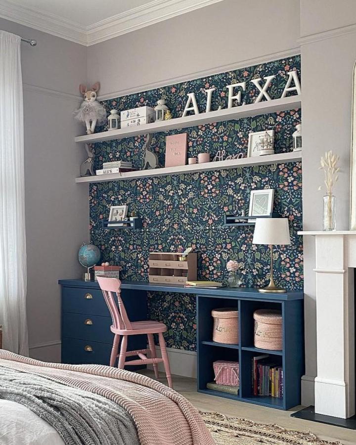 Navy blue painted ikea kallax desk hacks & ideas with pink accents and floral wallpaper from @styletheclutter. Cozy and organized workspace.