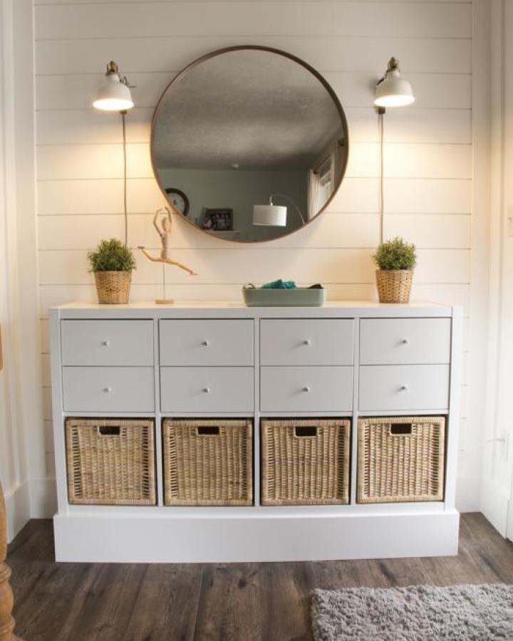 White Ikea Kallax dresser with woven basket drawers and a custom base from Remodelaholic for ikea kallax dresser hacks & ideas.