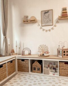 Neutral woven basket storage and wood bench Ikea Kallax playroom hacks & ideas from @kallaxshop.de featuring cozy corner layout and natural toys.