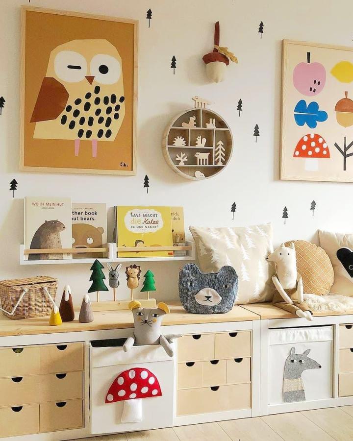 Whimsical fabric animal faces on wooden topped Ikea Kallax storage cubes in a playful kids playroom from @fuzzypeaks.