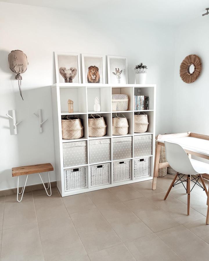 White and beige woven basket storage in ikea kallax playroom hacks & ideas from @home.deco.npernau with animal print art and natural accents