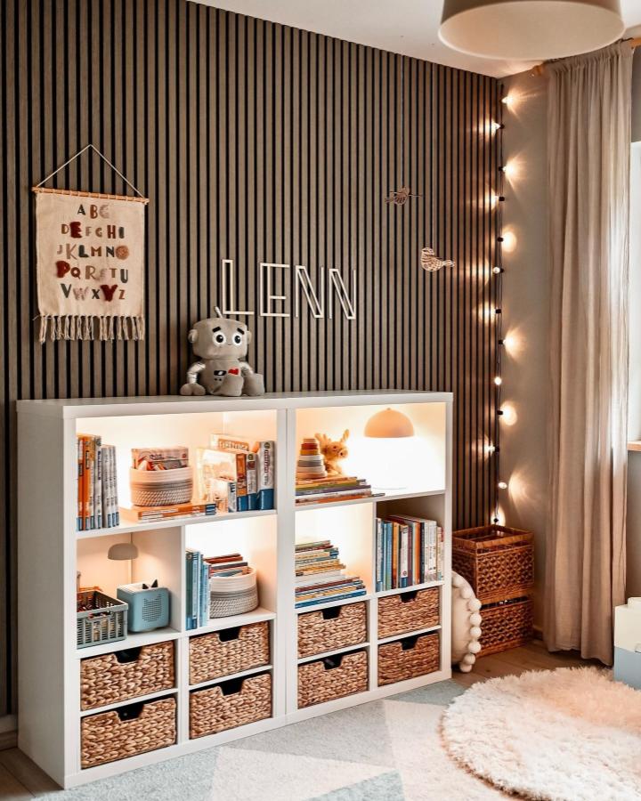 white ikea kallax playroom hack with woven baskets and warm interior lighting by @jul1186_home in cozy kids space