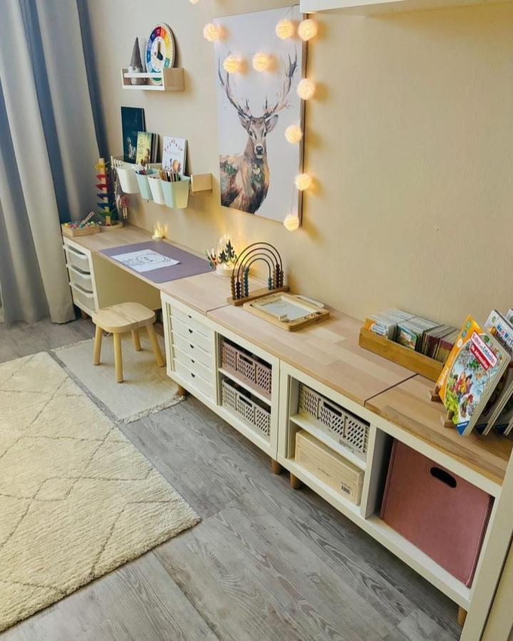Light wood topped ikea kallax playroom hacks & ideas storage with baskets, drawers, and cozy lighting from @newswedishdesign.