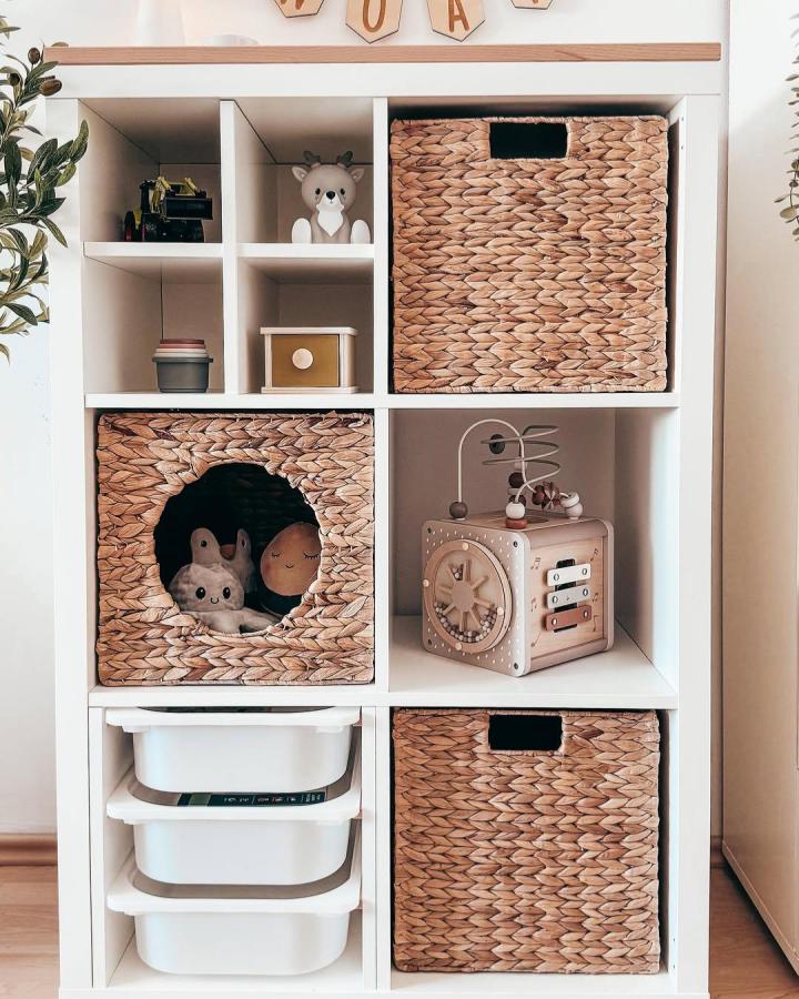 rustic woven basket ikea kallax insert hacks & ideas storage unit with a custom circular cutout hiding toys from @little.lion.love in cozy playroom corner