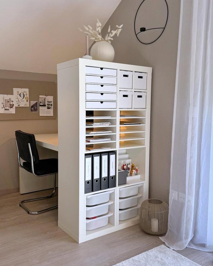 white minimalist storage unit from @janina_mirjam with paper trays and folders neat office corner ikea kallax insert hacks & ideas