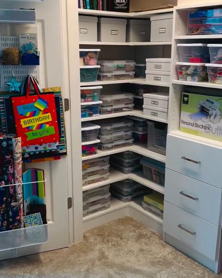 White and gray organized craft closet from @organizedmarie. Clear bins, labeled shelves, and drawer storage.