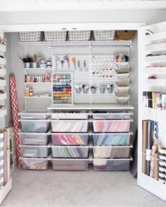 white pegboard craft closet from @prettypeachtree. Clear bins and hanging tools keep supplies tidy.