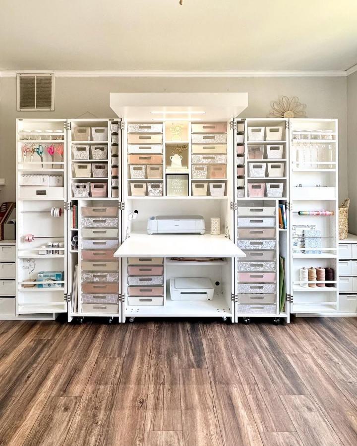 White and pastel Dream Box craft station craft closet from @createwithdesi. Neat bins, drawers, and shelves with a clean modern finish.
