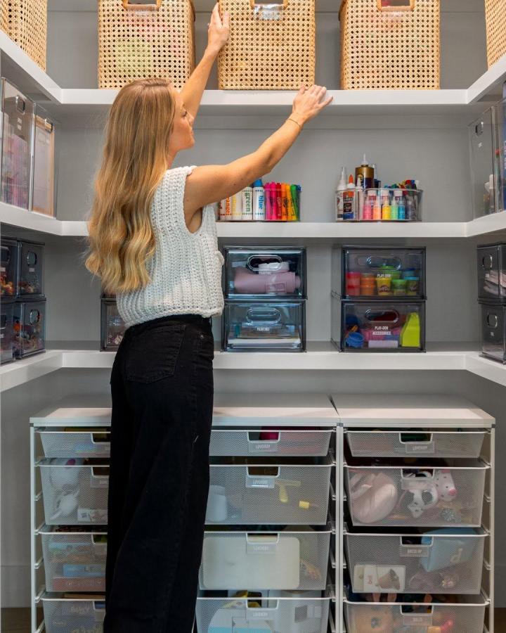 gray and woven craft closet from @heykarimoore. clear drawers and bins for craft closet ideas.