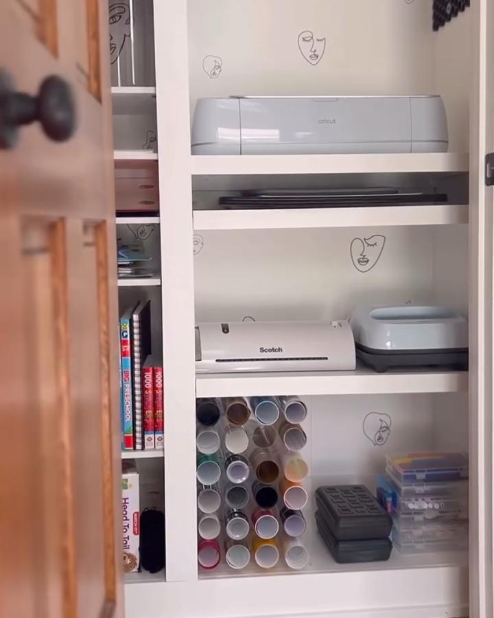 White craft closet with Cricut and storage from @diywithmeareke. Clean shelves and clear bins.