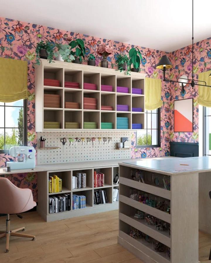 Pink floral craft room from The House That Lars Built. Pegboard, cubbies, and colorful bins keep supplies neat.
