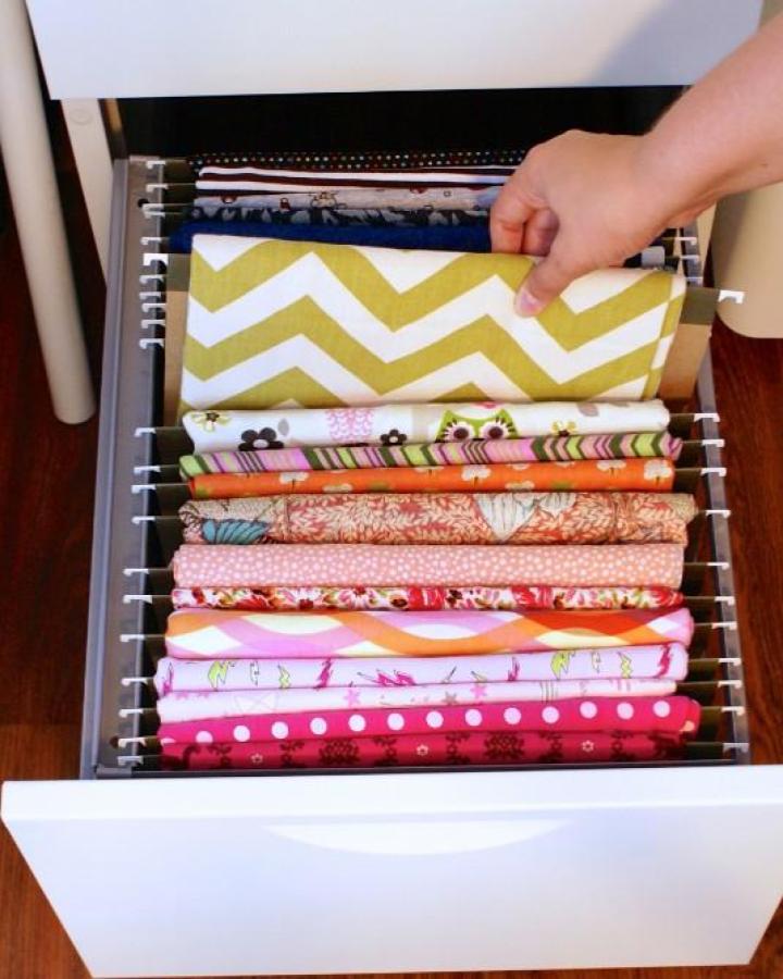 yellow chevron fabric drawer from Thinking Closet. craft room organization ideas with stacked patterned cottons.