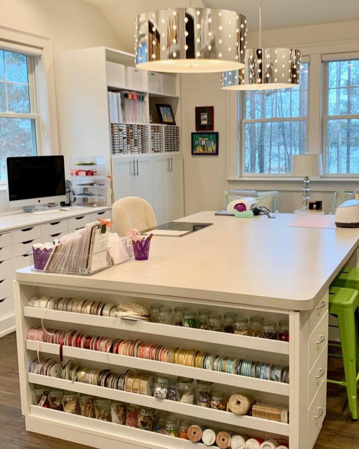 white ribbon storage island from Positively Jane. Color-sorted rolls and clear jars keep supplies neat.